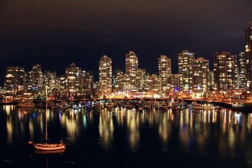 Canadian cityscape reflecting on water at night
