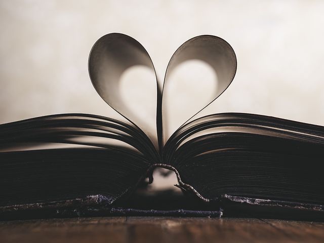 A book with pages folded into a heart. 